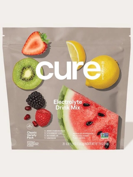 A high-clarity 3:4 product hero shot of an electrolyte drink mix pouch, surrounded by fresh, sliced fruit ingredients on a neutral beige background.